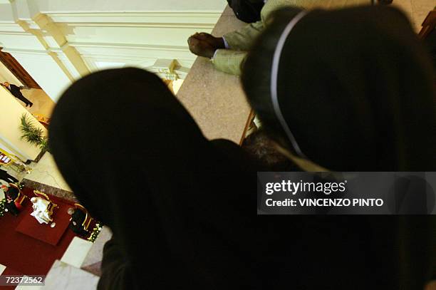 Two nuns look at Pope Benedict XVI during his visit at the Pontifical Gregorian University in Rome 03 November 2006. The Vatican and Ankara both...