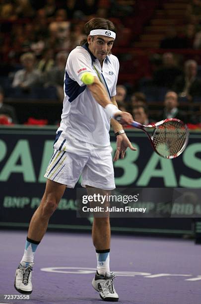 Tommy Robredo of Spain plays a backhand in his match against Jarkko Nieminen of Finland in the quarter finals during day five of the BNP Paribas ATP...