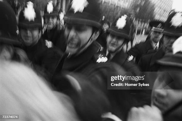 Police grab at a demonstrator during an Anti-Vietnam War demonstration outside the US embassy in Grosvenor Square, London, 1968.