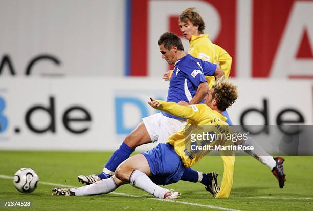 Marcel Schied of Rostock and Holger Hasse of Jena fight for the ball during the Second Bundesliga match between Hansa Rostock and Carl Zeiss Jena at...