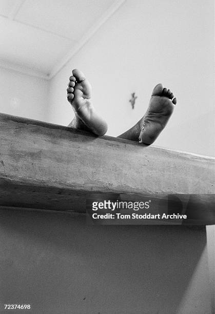 The body of a small boy lies in a morgue in Lusaka, Zambia, as another African child becomes a tragic AIDS statistic. It is estimated that 25.4...