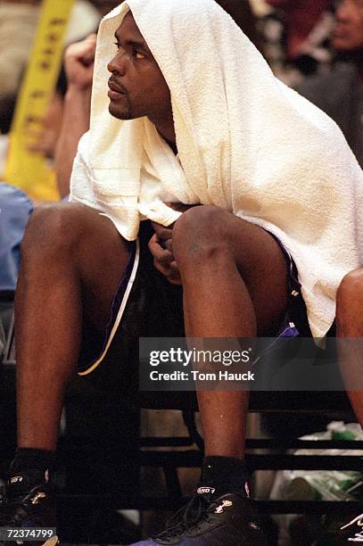 Chris Webber of the Sacramento Kings looks on as he wears a towel on the bench during the NBA Western Conference Playoffs Round One Game against the...