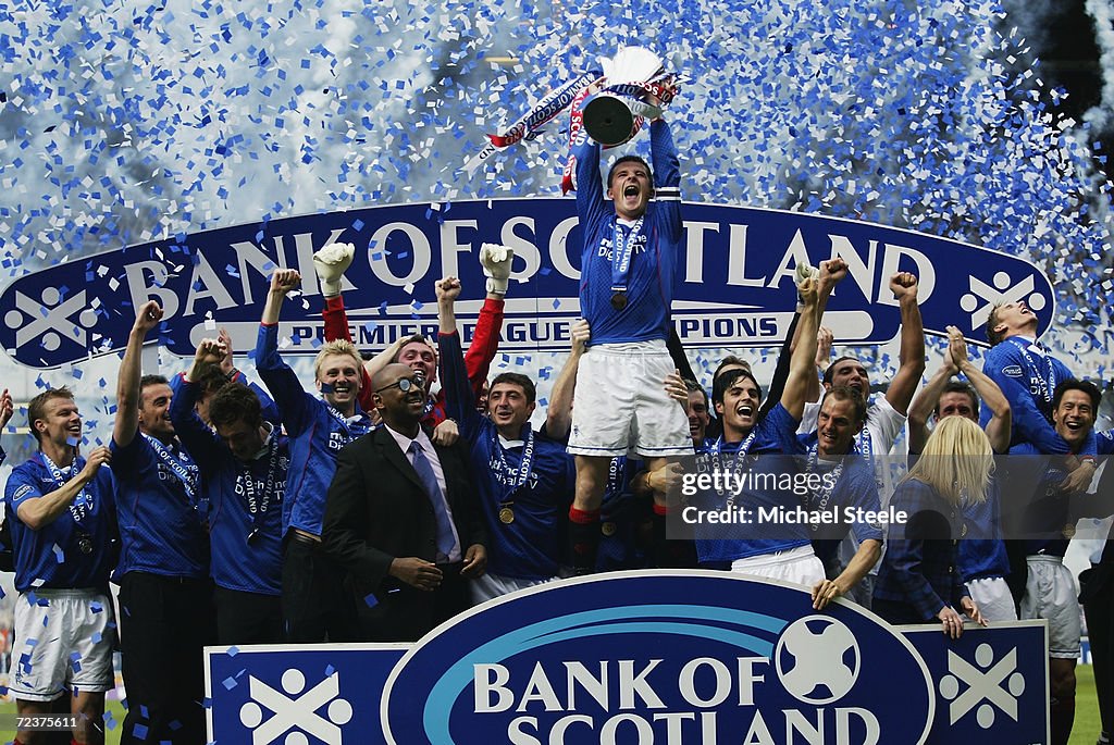 Rangers captain Barry Ferguson lifts the trophy up as he celebrates winning the league with his team-mates
