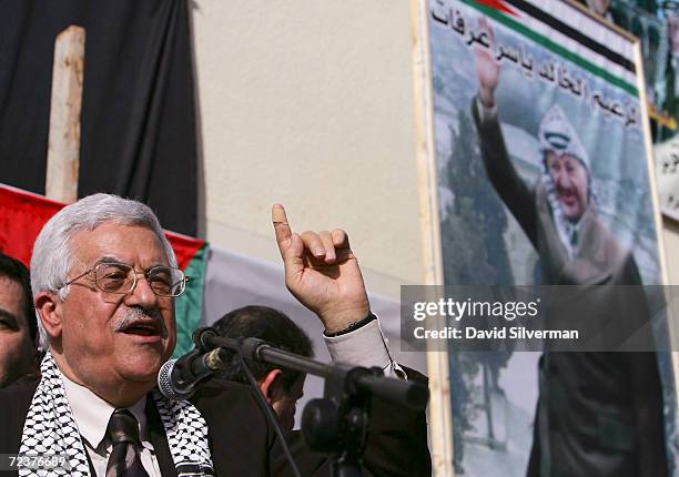 Interim Palestinian leader Mahmoud Abbas addresses the crowd below a Yasser Arafat poster as he campaigns for the upcoming January 9 presidential...