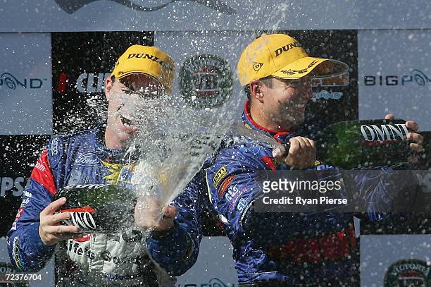 Craig Lowndes of the Triple Eight Racing Team and Marcos Ambrose of the Stone Brothers Racing Team celebrate after race two of the Clipsal 500 which...