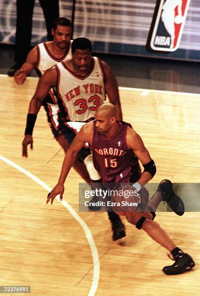 Vince Carter of the Toronto Raptors moves around the Patrick Ewing and Latrell Sprewell of the New York Knicks during Game 2 of the quarter-finals of...
