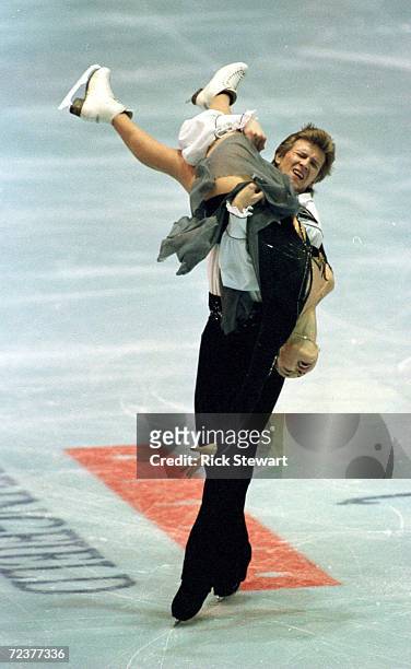 Oleg Ovsiannikov holds partner Anjelika Krylova as they skate their original dance program to wins the ice dance competition of the Thrifty Car...