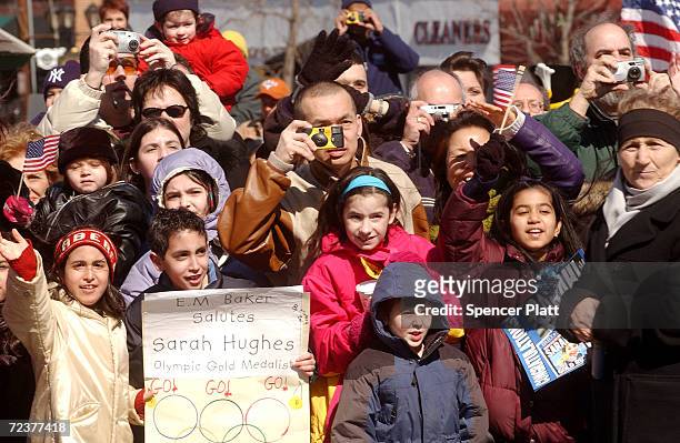 Fans of Olympic figure skating gold medalist Sarah Hughes watch a parade in Hughes'' honor March 10, 2002 in her hometown of Great Neck, NY.