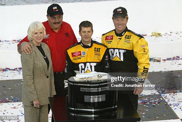 Ward Burton driver of the Bill Davis Racing Dodge Intrepid R\\T celebrates with team onwers Bill and Gail Davis and crew chief Tommy Baldwin after...