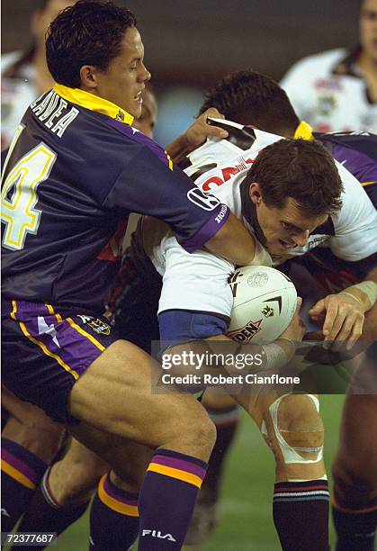 Matthew Adamson of the Penrith Panthers is tackled by Tasea Lavea of the Melbourne Storm, during the NRL round 24 match between the Melbourne Storm...