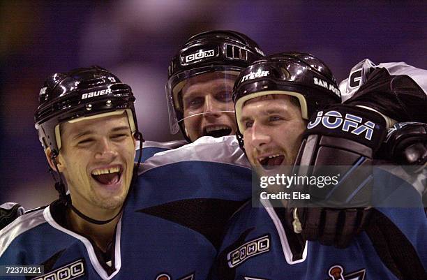 Todd Harvey, Vincent Damphousse and Bryan Marchment of the San Jose Sharks celebrate their 4-2 win over the St. Louis blues during game two of the...