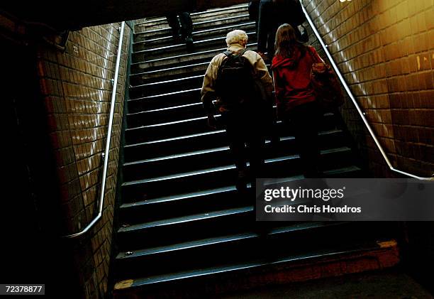 Riders wealk up the steps of the West 4th Street subway station October 26, 2004 in New York City. The New York City subway system opened 100 years...