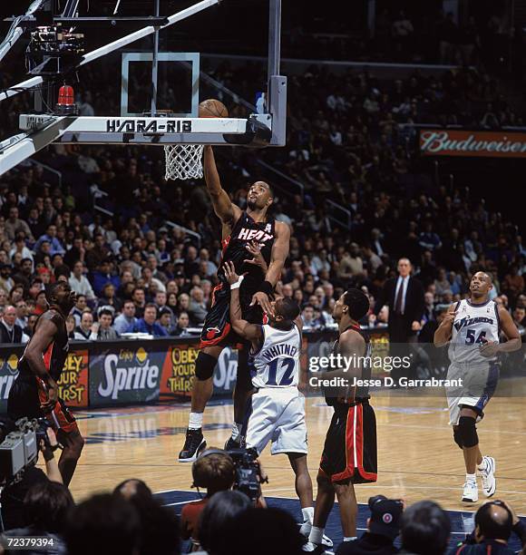 Center Alonzo Mourning of the Miami Heat shoots over guard Chris Whitney of the Washington Wizards during the NBA game at the MCI Center in...