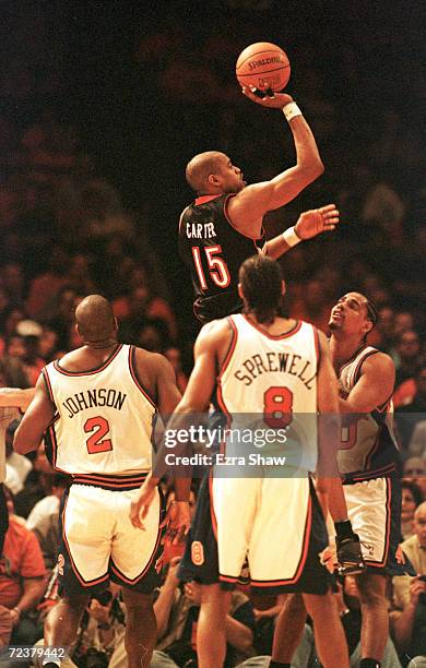 Vince Carter of the Toronto Raptors puts up a jumper over three New York Knicks during their game at Madison Square Garden in New York City. The...