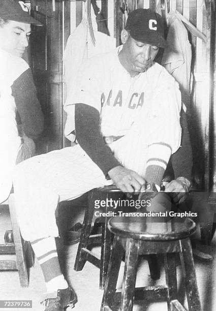 Martin Dihigo, pitcher and outfielder for the Caracas team in the Venezuelan league, dresses for an upcoming game in Caracas in 1933.