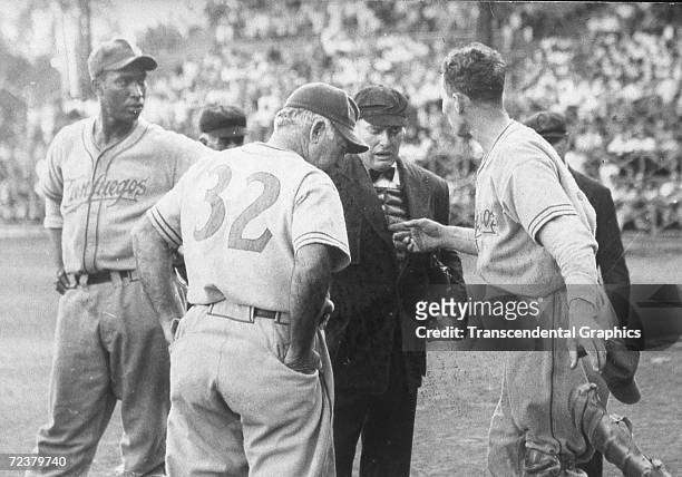 Martin Dihigo, manager of the Cienfuegos Baseball Club, left, argues with Adolfo Luque, manager of Habana, number 32, and the umpire during a gameat...