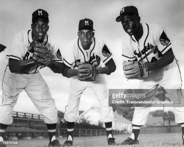 Hank Aaron, right, poses with fellow Milwaukee Braves outfielders Wes Covington, left, and Bill Bruton at Bradenton, Florida spring training complex...