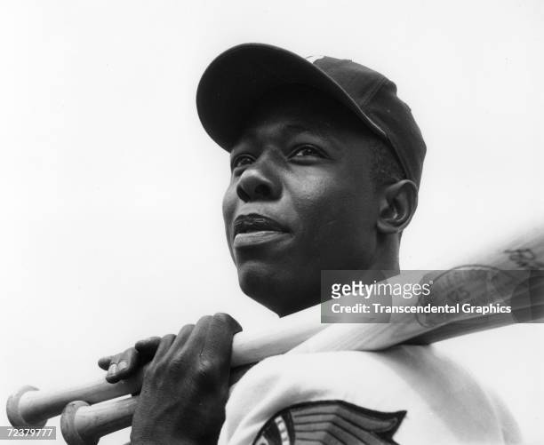 Hank Aaron, outfielder for the Milwaukee Braves, poses with his bats before a game at County Stadium in 1960.