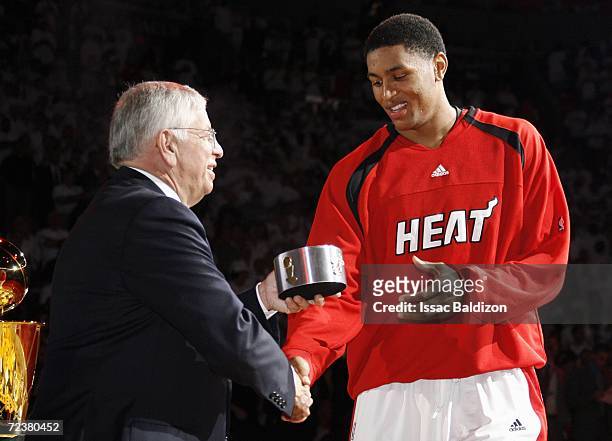 Wayne Simien of the Miami Heat shakes hands with NBA Commissioner David Stern as he receives his ring during the ceremony honoring the Miami Heat for...