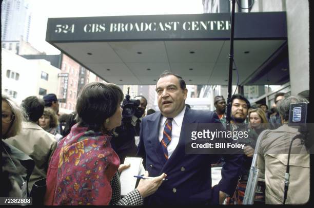 Correspondent Ike Pappas speaking to a reporter outside the CBS building during a writers strike.