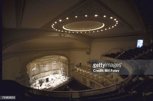 Carnegie Hall interiors during renovation with painters at work.