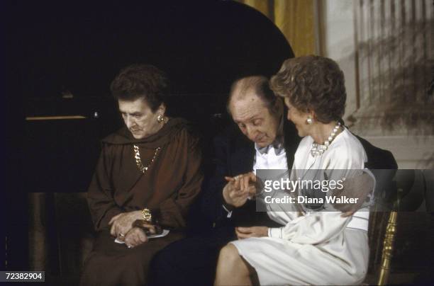 Nancy Reagan comforted by Vladimir Horowitz with Mrs. Horowitz .