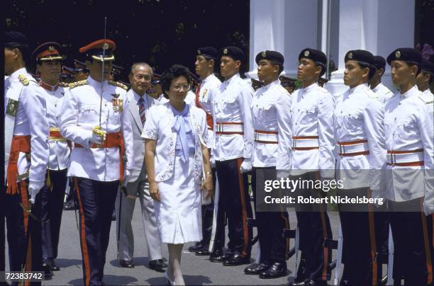 Philippine President Corazon Aquino during visit to Singapore reviewing troops.