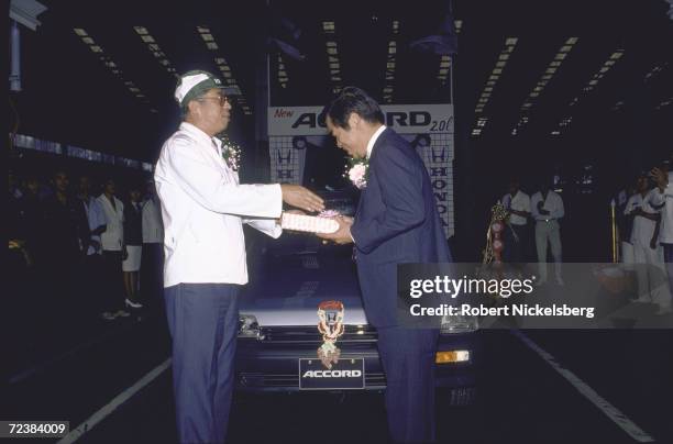 Celebration of launching of new Honda 2 litre Accord, with employees & Japanese & Thai company officials on hand, at manufacturing plant.