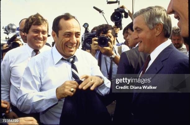 President Candidate Walter Mondale with Mario Cuomo, and many photographers and press inc. Reporter Tim Russert at Logan Airport, Boston.