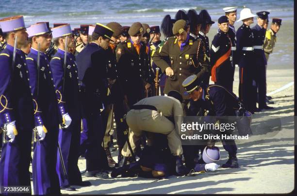 Female cadet from French Ecole Militaire faints during ceremonies on 40th anniversary of D-Day on Utah beach, Normandy.