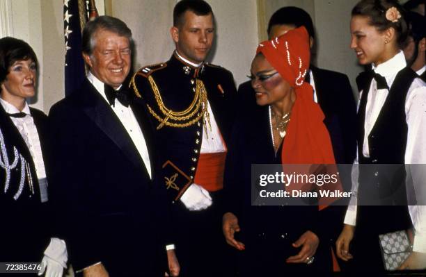 President Jimmy Carter in reception line about to greet singer / actress Eartha Kitt