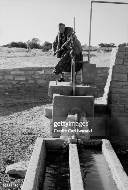 Presidential Medal of Freedom winner Annie Wauneka pumping water from the well in her Navajo village.