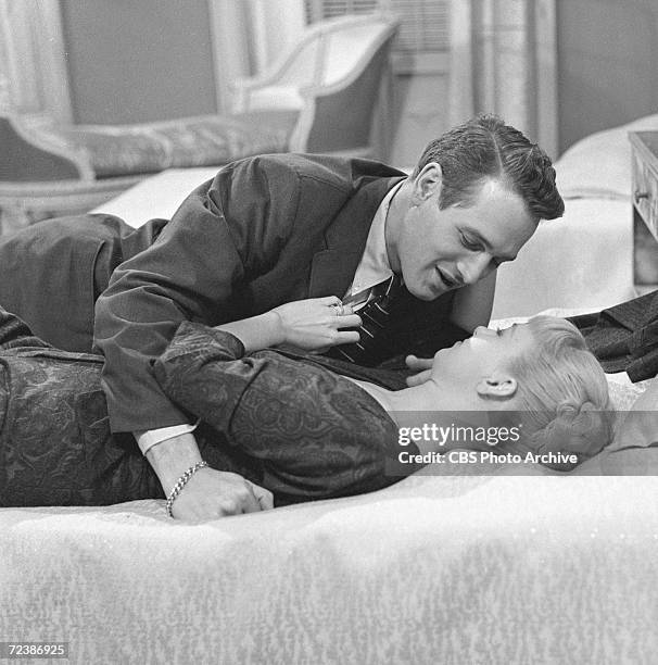 American actors Paul Newman and Joanne Woodward share an intimate moment in a scene from an episode of Playhouse 90 entitled 'Eighty-Yard Run,'...