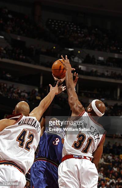 Guard Allen Iverson of the Philadelphia 76ers shoots over forward Scott Williams and point guard Nick Van Exel of the Denver Nuggets during the NBA...