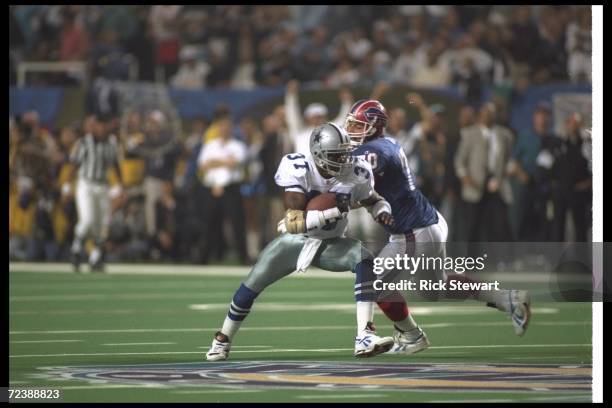 Defensive back James Washington of the Dallas Cowboys attempts to evade a Buffalo Bills player after intercepting the ball during the third quarter...