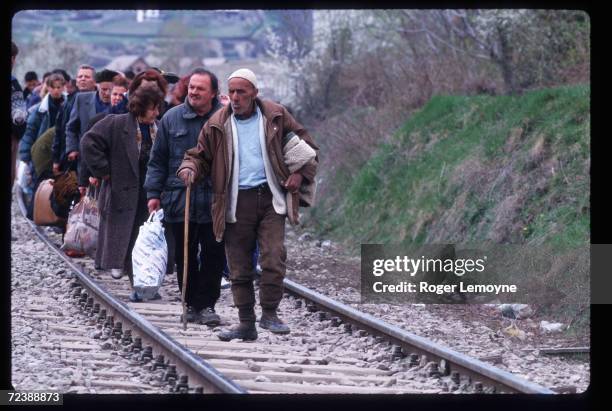 Group of refugees walk along railroad tracks April 1, 1999 in Macedonia. Thousands of Kosovar Albanians fled the violence in Serbia and arrived at...