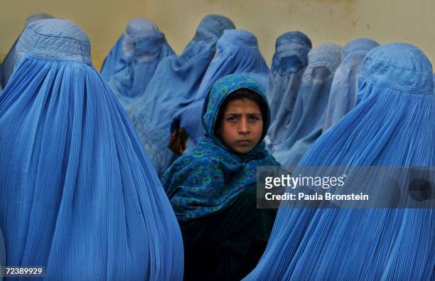 Afghan women wait in line to be treated at the Kalakan health clinic February 23,2003 in Kalakan, Afghanistan.