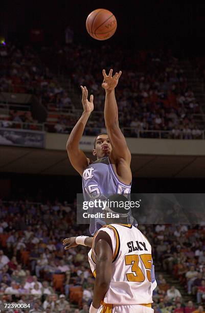 Julius Peppers of North Carolina takes a shot as Ron Slay of Tennessee defends during the NCAA South Regional at the Frank Erwin Center in Austin,...