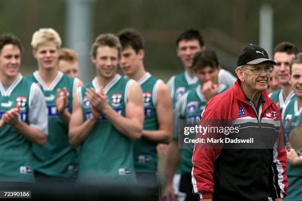 Former St Kilda Football club premiership coach Allan Jeans is applauded by players after taking a series of training drills, during the clubs...