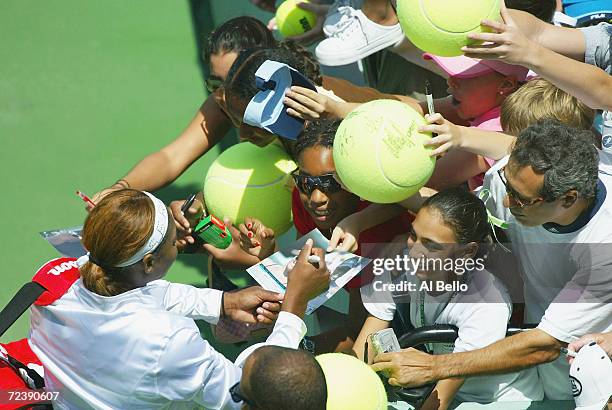 Serena Williams of the USA signs autographs after defeating Marta Marrero of Spain during The Nasdaq 100 on March 26, 2004 in Miami, Florida.