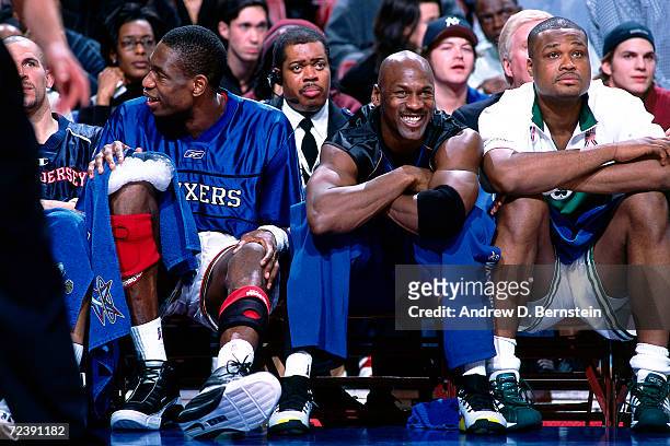 Dikembe Mutombo of the Philadelphia 76''ers, Michael Jordan of the Washington Wizards and Paul Pierce of the Boston Celtics take a break on the bench...