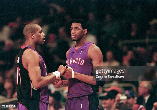 Vince Carter of the Toronto Raptors shakes hands with teammate Tracy McGrady during round one of the NBA Playoffs against the New York Knicks at the...