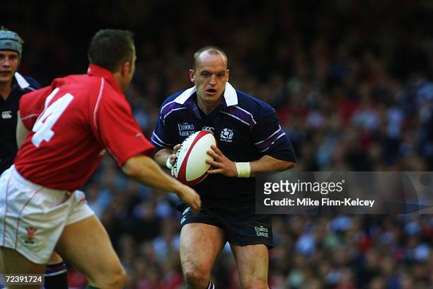 Gregor Townsend of Scotland looks to take the ball past Rhys Williams of Wales during the Lloyds TSB Six Nations Championship match played at the...
