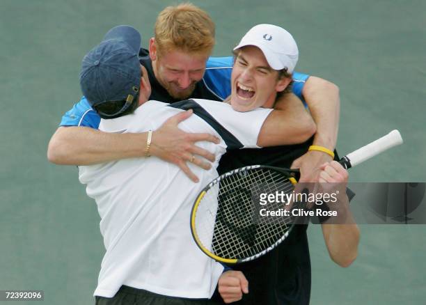 Andrew Murray, David Sherwood and coach Jeremy Bates of Great Britain celebrate after they beat Andy Ram and Jonathan Erlich of Israel during the...