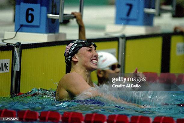 Amy Van Dyken of the USA celebrates after winning the Gold in the Womens 100 Butterfly event during the 1996 Olympic Games at Georgia Tech Aquatic...