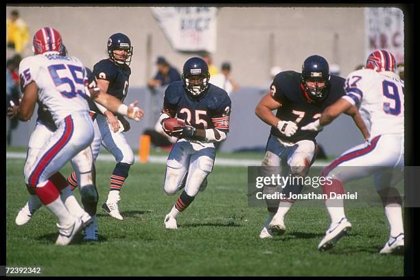 Running back Neal Anderson of the Chicago Bears runs through a hole during a game against the Buffalo Bills at Soldier Field in Chicago, Illinois....