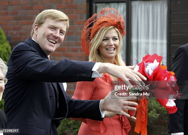 His Royal Highness The Prince of Orange explains his knowledge of the game bowls to Princess Maxima of The Netherlands as they pass a bowling green...