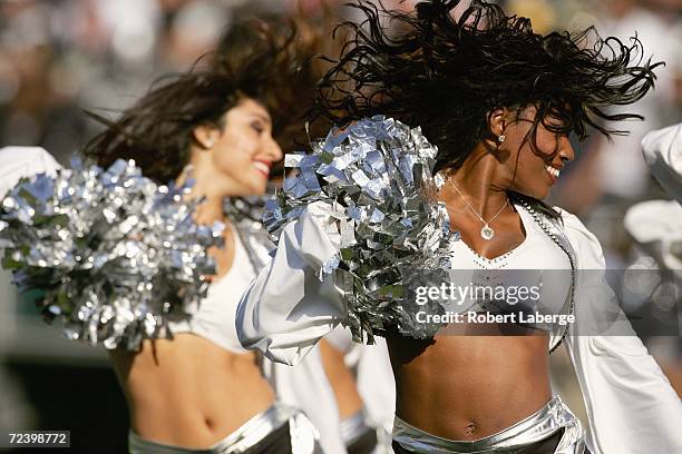 Oakland Raiderettes Cheerleaders perform on the field during an NFL game between the Oakland Raiders and the Pittsburgh Steelers at McAfee Coliseum...