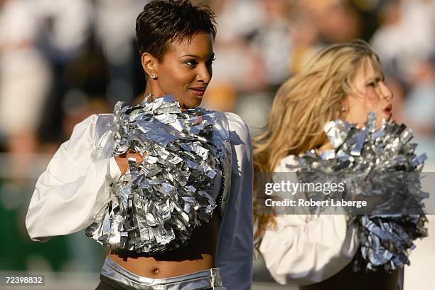 Oakland Raiderettes Cheerleaders perform on the field during an NFL game between the Oakland Raiders and the Pittsburgh Steelers at McAfee Coliseum...