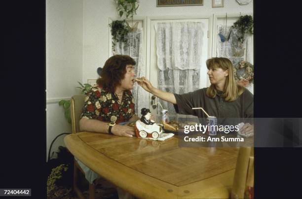 Partially paralyzed singer/songwriter Jan Berry , former member of '60s surf-rock duo Jan & Dean, being fed in the kitchen by his wife Gertie Filip...